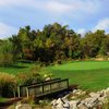 A view of a hole with bridge in foreground at Far Oaks Golf Club