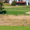 A view of green with clubhouse in background at Redtail Golf Club