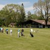 A view of the driving range tees with clubhouse and pro shop in background at 	Zigfield Troy Golf Range & Par 3