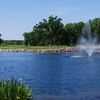 A view of green with water fountain in foreground at Cantigny Golf