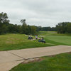 A view of fairway with golf carts in background at Coyote Creek Golf Club
